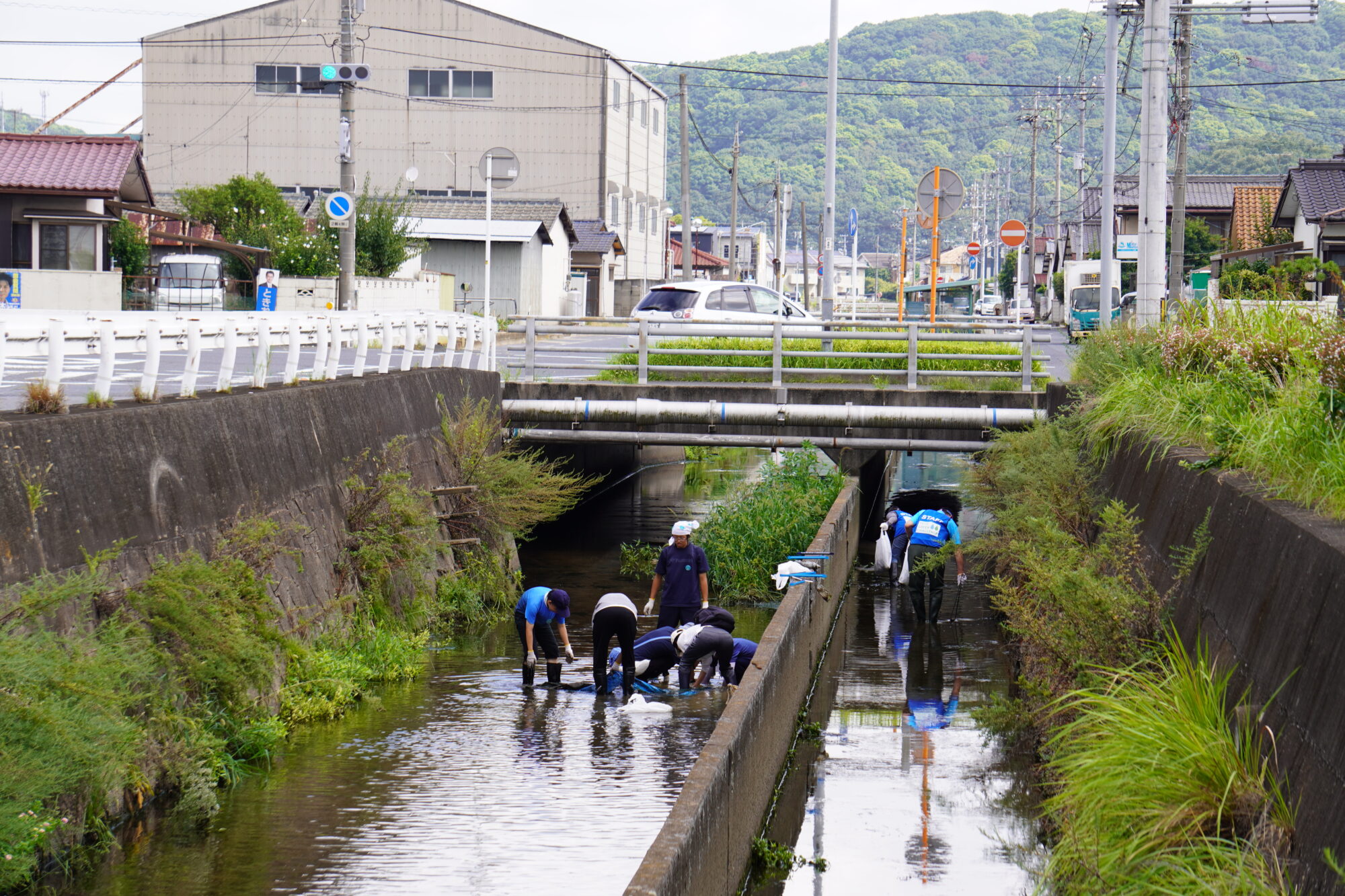 住宅地の真ん中を流れる八間川でごみの回収活動（倉敷市水島東川町）