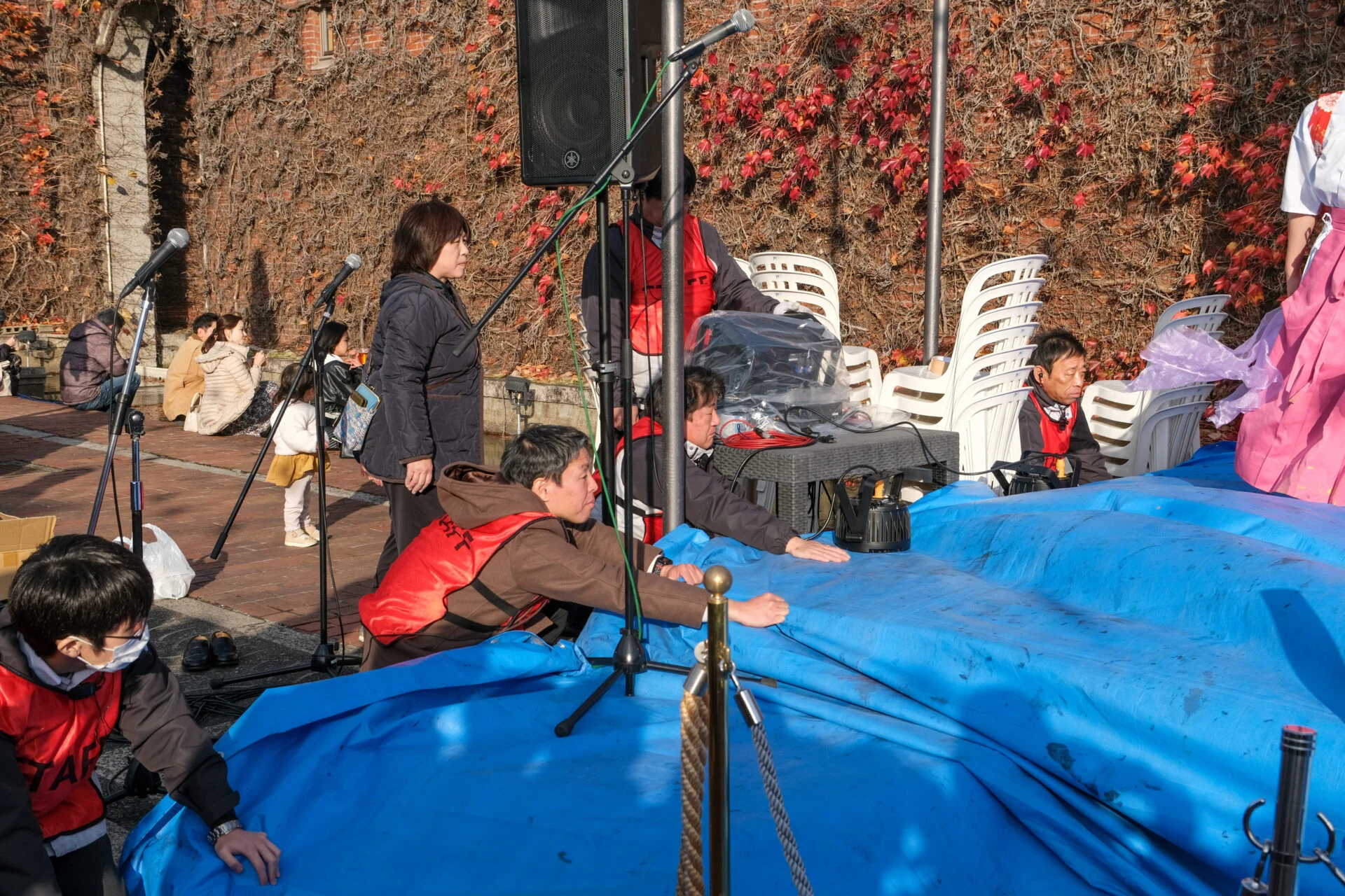 紙を押さえるスタッフ