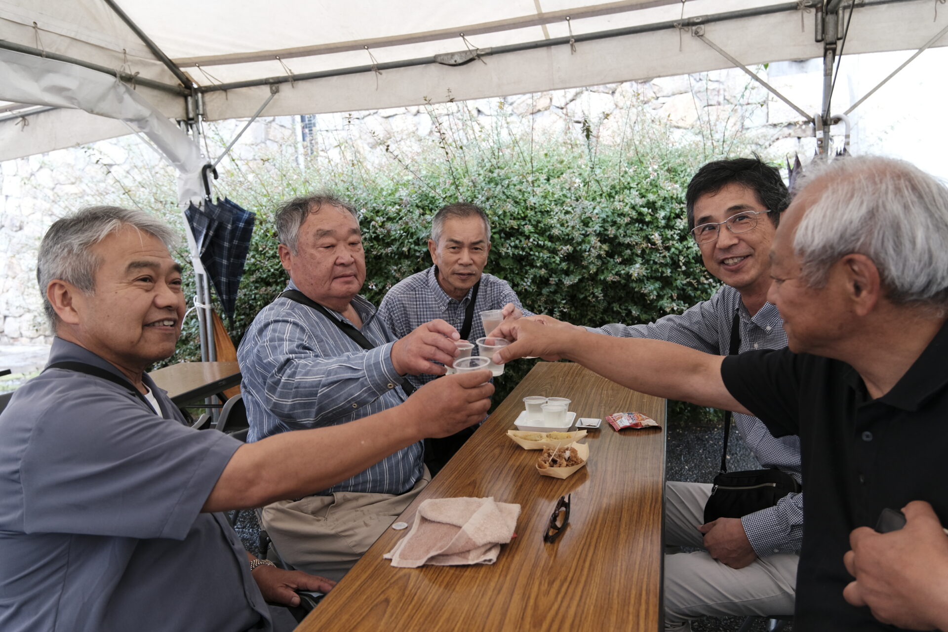 雨の中地酒を楽しむ来場客