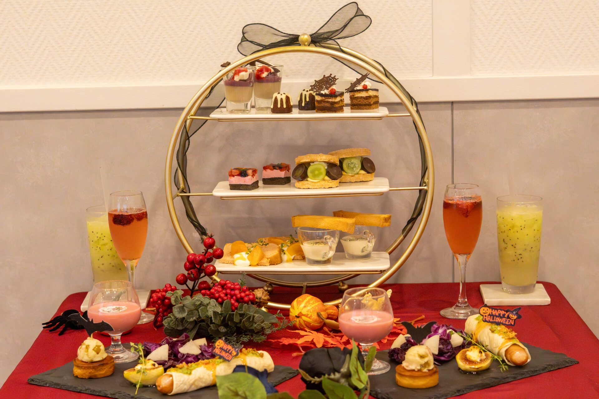 Sweets and drinks from Kurashiki Halloween Afternoon Tea arranged on a three-tier stand